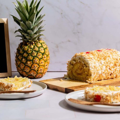 Brazo de piña colada | Pastelería Ciro Guatemala | Brazo gitano de bizcocho de vainilla esponjoso, relleno de mermelada de piña y envuelto en crema suave de vainilla. Un postre festivo y frutal con el equilibrio perfecto entre dulce y fresco.